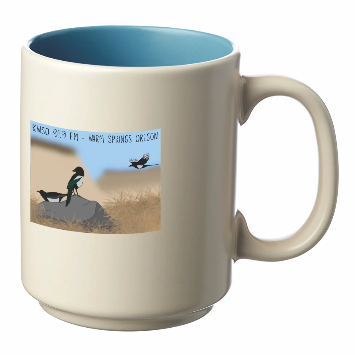 Cream ceramic mug with a blue inside and a KWSO 91.9 FM Warm Springs Oregon magpie scene